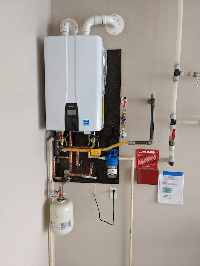 Professional plumber installing copper piping in a Fruit Cove home